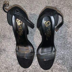 Chunky black heels with a clear strap